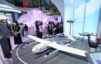 People view an unmanned aerial vehicle (UAV) displayed at the Fifth Silk Road International Exposition