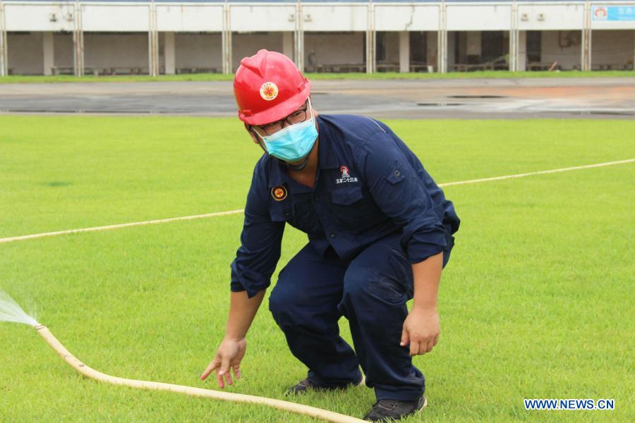 Beninese, Chinese workers work at renovation site of Friendship Stadium in Cotonou