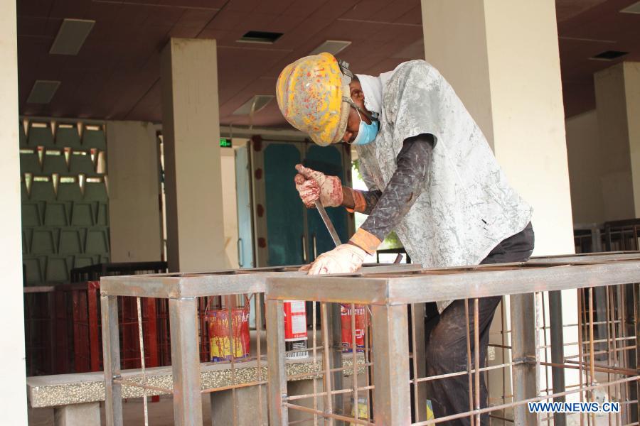 Beninese, Chinese workers work at renovation site of Friendship Stadium in Cotonou